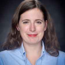 picture of stephanie perpick wearing a blue shirt on a dark background