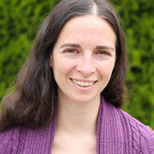 White woman with long, brown hair and hazel eyes